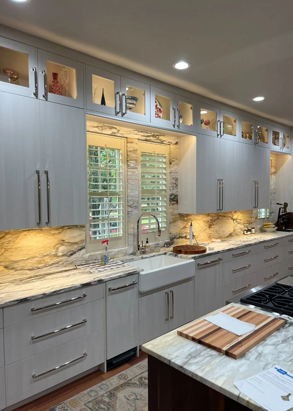 Kitchen with a farmhouse sink, granite counters and plantation shutters