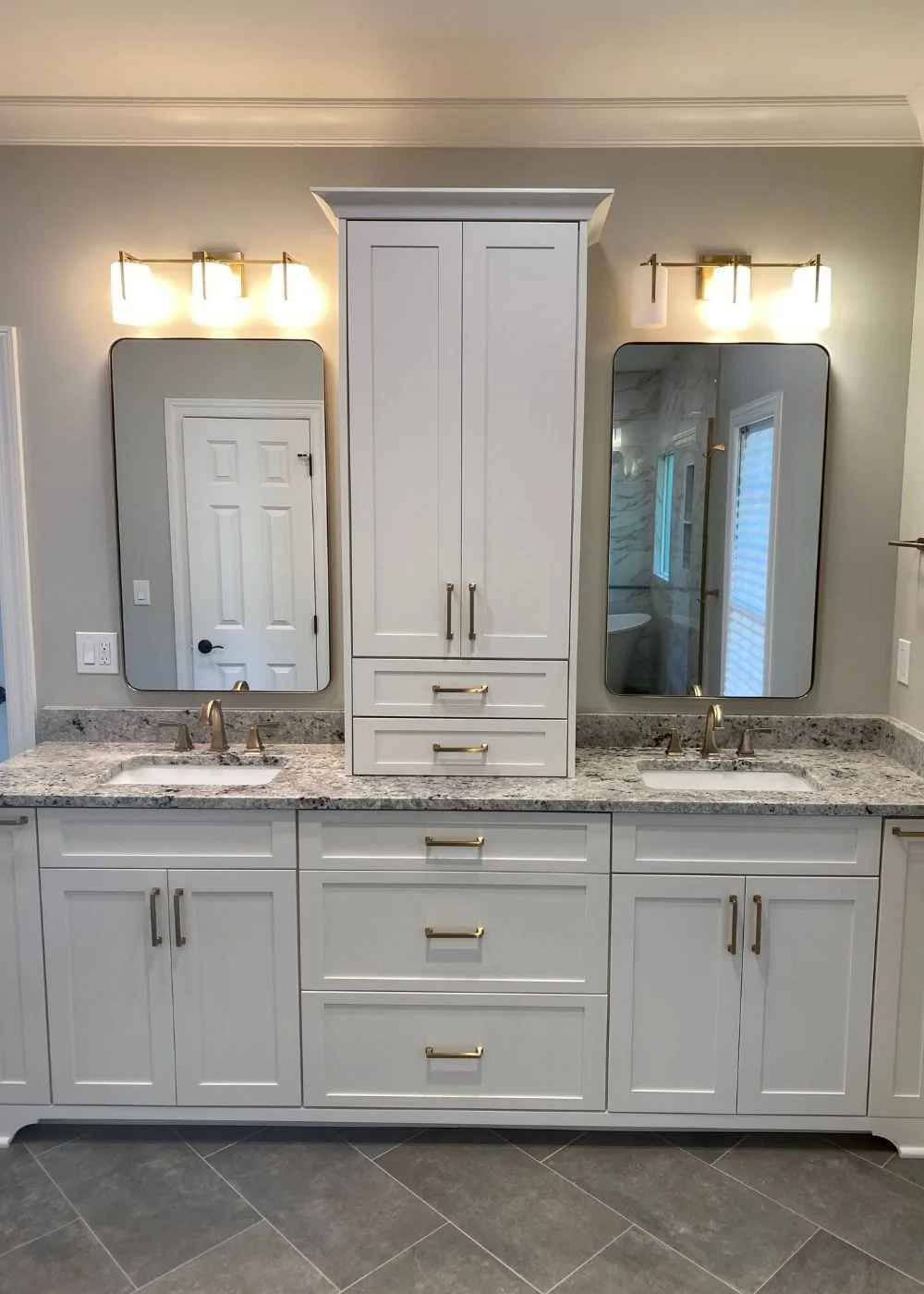 Bathroom with a double vanity and a center storage tower